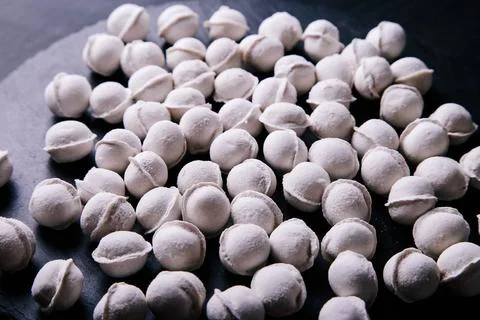 Raw dumplings background on a dark background Stock Photos