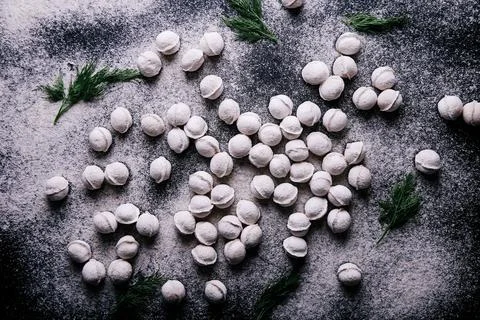 Raw dumplings background on a dark background. Stock Photos