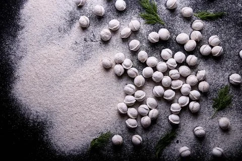 Raw dumplings background on a dark background Stock Photos