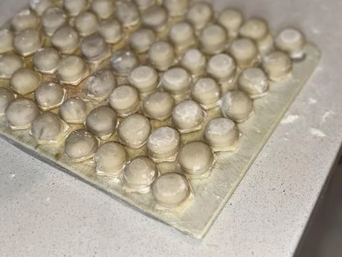 Raw Dumplings on Floured Surface Stock Photos
