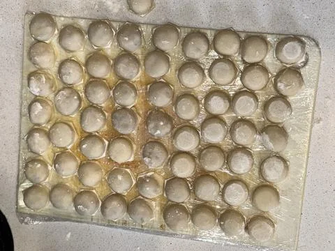 Raw Dumplings on Floured Surface Stock Photos