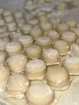 Raw Dumplings on Floured Surface Stock Photos