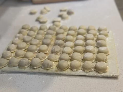 Raw Dumplings on Floured Surface Stock Photos