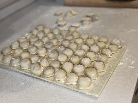 Raw Dumplings on Floured Surface Stock Photos