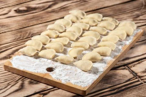 Raw dumplings on wooden cutting board, is ready to boil. Also known as Vareni Stock Photos