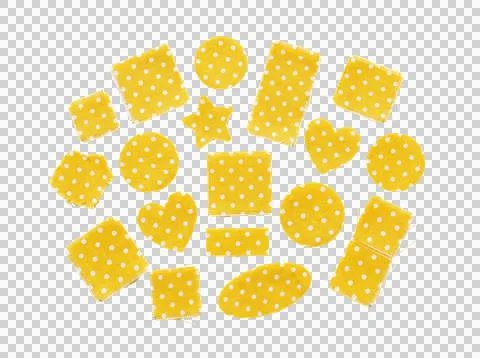 Raw edge yellow polka dot cloth scraps in geometric shapes. Stock Photos