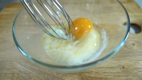 Raw egg and sugar mix in a whisk in slow motion Stock Footage 131808359