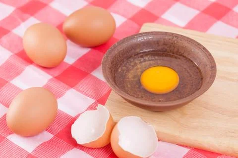 Raw egg in bowl on the table Stock Photos