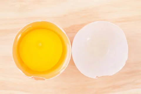 Raw egg on egg shell Stock Photos