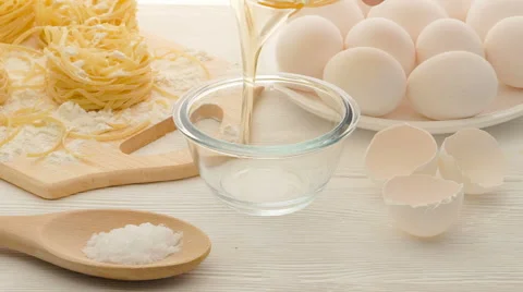 Raw egg falling into glass bowl and splashing Stock Footage 62064568