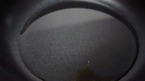 Raw Egg Falling on Pan in Slow Motion Stock Footage 129261777