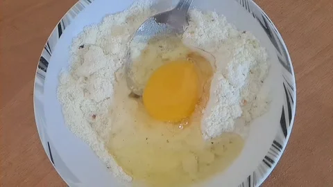 Raw egg falling into ras malai powder Stock Footage 318339940