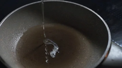 Raw egg falls to the hot pan in a slow motion, scrambled eggs and omelette Stock Footage 81368504
