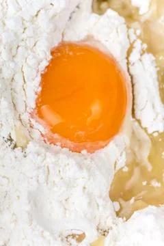 Raw egg in the flour macro shot Stock Photos