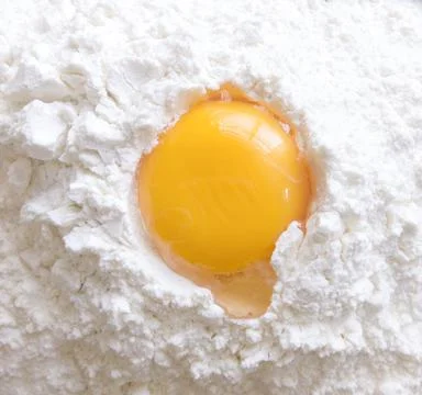 Raw egg in flour. Stock Photos