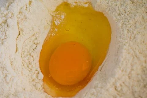 Raw Egg in Flour Well for Baking Preparation, Top View Stock Photos