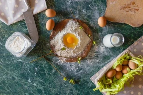 Raw egg in a handful of flour. Spring pie cooking. Top view Stock Photos