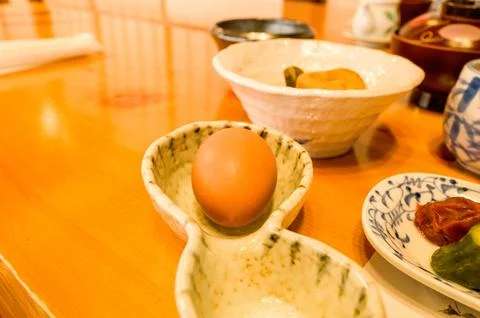 Raw egg in marbled ceramic dish at breakfast Stock Photos
