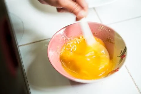 Raw egg prepared for omelet Stock Photos