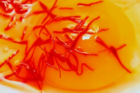 Raw egg with saffron Stock Photos