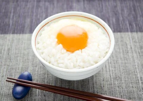 Raw egg sauce over rice Stock Photos