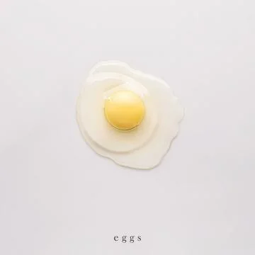 Raw egg on a white background. top view. minimalistic food art, healthy food Stock Photos