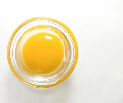 Raw egg without shell on a white background. Stock Photos
