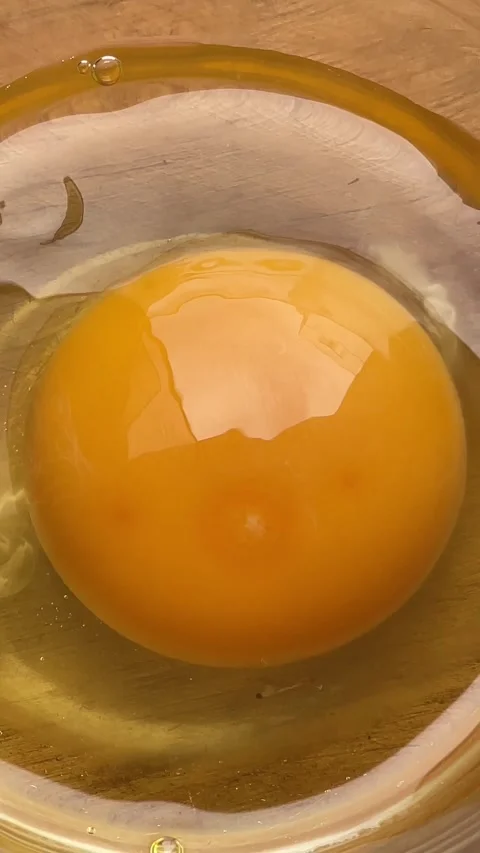 Raw egg yolk approach Stock Footage 287667170