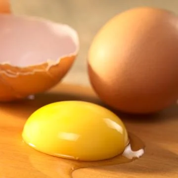 Raw egg yolk Stock Photos