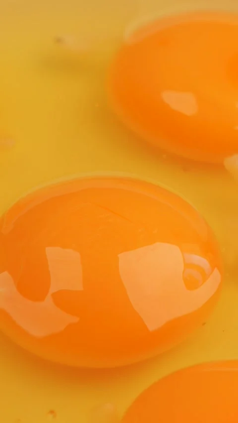 Raw egg yolks close-up, rotation in circle. fresh eggs for recipe preparation, Stock Footage 323331733