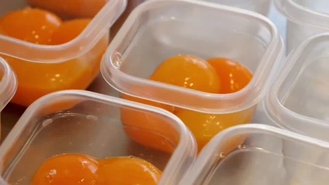 Raw Egg Yolks in Portion Containers, Ready for Freezing or Storage Stock Footage 331772560