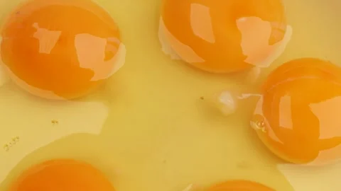 Raw egg yolks, rotation in circle. fresh eggs for cooking preparation, Turning. Stock Footage 323331760