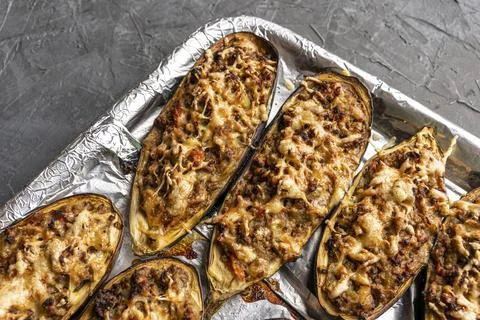 Raw eggplant with meat on a baking sheet Photos
