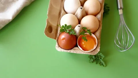 Raw eggs in carton with baking tools and herbs composition Stock Footage 334119177