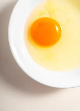Raw eggs. Close up. flat lay raw eggs yolk in bowl. Isolated broken white b.. Stock Photos