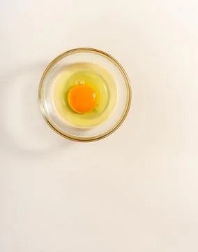 Raw eggs. Close up. flat lay raw eggs yolk in bowl. Isolated broken white b.. Stock Photos