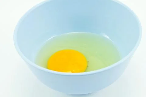 Raw eggs in a cup Stock Photos