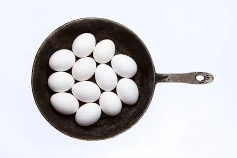 Raw eggs in frying pan Stock Photos