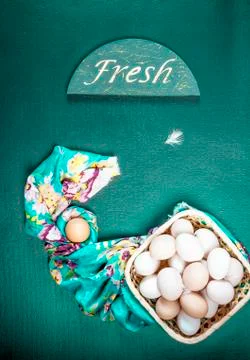 Raw eggs on the green background Stock Photos