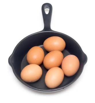 Raw eggs in a pan Stock Photos