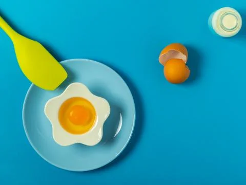 Raw eggs on a solid blue color background Stock Photos