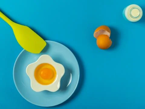 Raw eggs on a solid blue color background Stock Photos