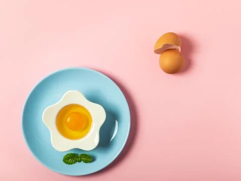Raw eggs on a solid pink color background Stock Photos