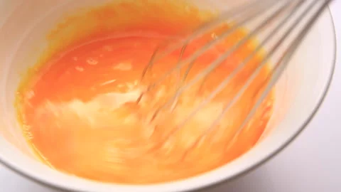 Raw eggs stirred Stock Footage 161843736