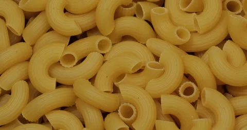 Raw elbow macaroni pasta closeup. Food concept. Pasta background. Stock Footage 307998459