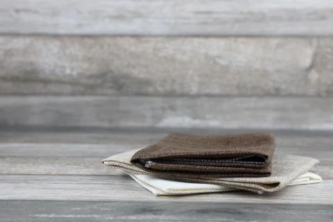 Raw fabrics stacking on wood background Stock Photos