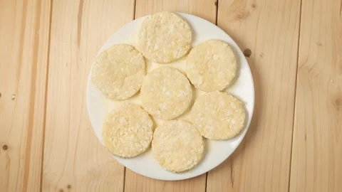 Raw farmer cheese pancakes rotating on plate Stock Footage 340159627