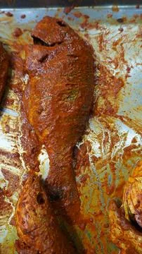 Raw fish coated in thick spice paste on tray Stock Photos