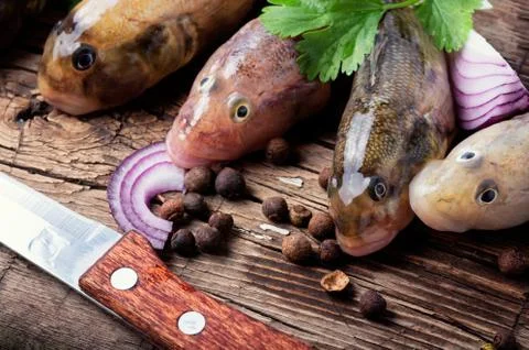 Raw fish on cutting board Stock Photos