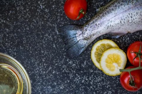 Raw fish on dark background Stock Photos